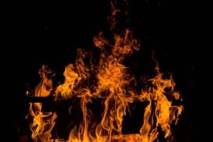 Vivid depiction of orange flames dancing in the dark, showcasing fire's power.